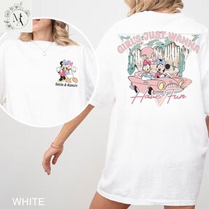 A white t-shirt with a graphic design featuring Minnie Mouse and the text "Girls Just Wanna Have Fun" printed on the back.