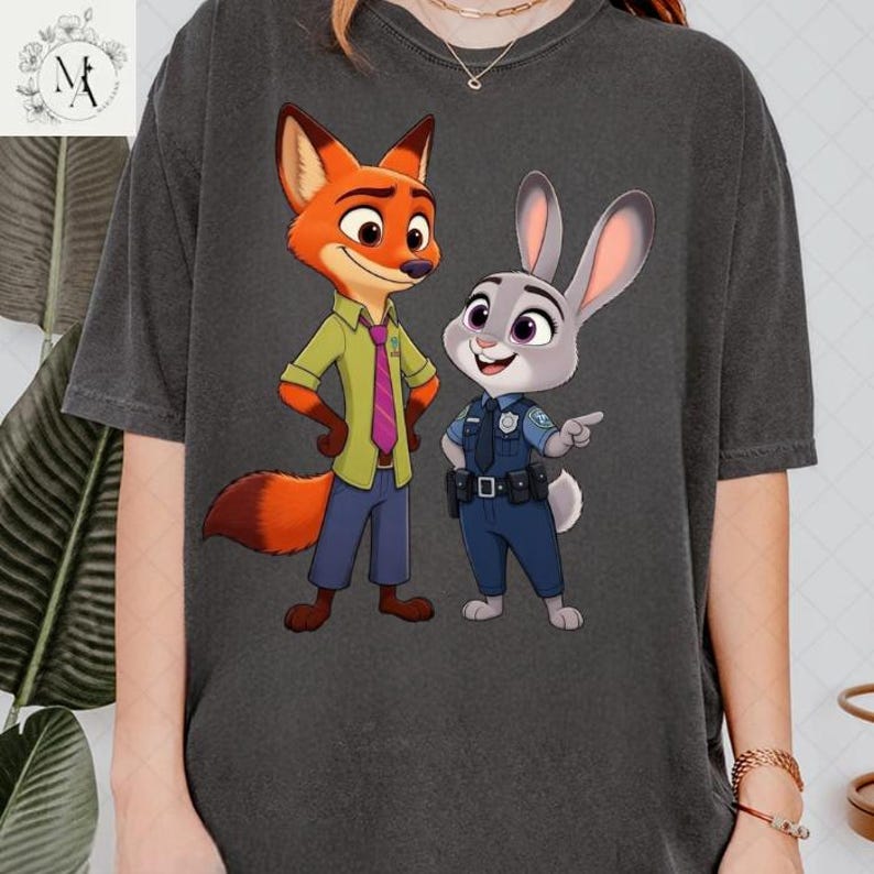 A person wearing a gray t-shirt with a graphic of two cartoon police characters, a fox and a rabbit, standing together.