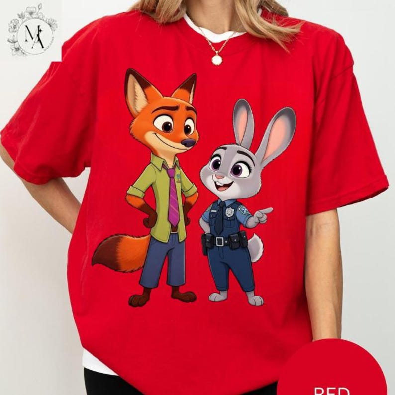 A red t-shirt with a cartoon image of a fox and a rabbit, both wearing police uniforms, standing together.