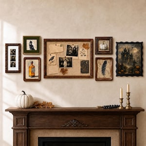 May include: A gallery wall arrangement featuring a large central cork bulletin board surrounded by various framed prints including a black cat, a potion bottle, a white pumpkin, a feather, and a dark castle scene, all displayed above a wooden mantel.