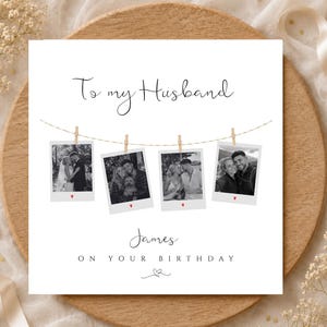 May include: A square greeting card with the text To my Husband at the top. Below, four black and white photos of a couple hang from a string with wooden clips. Each photo has a small red heart. The name James and ON YOUR BIRTHDAY appear below.