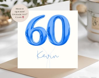 May include: A white greeting card with a blue '60' balloon design and the name 'Kevin' in blue script. The card also has text that reads 'Need it Quicker? Upgrade to 1st Class'.