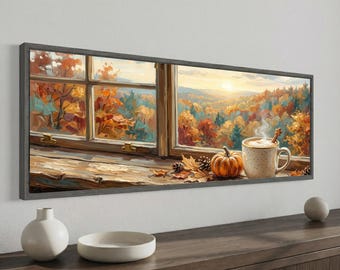 May include: A framed panoramic wall art print depicting a window view of an autumn landscape with orange and yellow trees. On the wooden windowsill sits a steaming mug of coffee, a small orange pumpkin, and pinecones under a soft sunset sky.