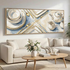 May include: An abstract painting of a table setting in light blue and cream. The artwork depicts plates, bowls, cutlery, and a teapot with a creamer. The painting is in a rectangular wooden frame.