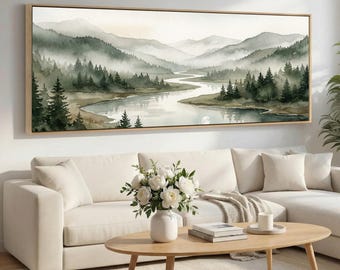 May include: A framed watercolor landscape painting depicting a river winding through a valley surrounded by misty mountains and evergreen trees. The artwork features a muted color palette of greens, grays, and browns, creating a serene and natural scene.