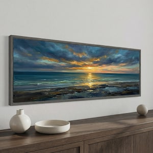 May include: A rectangular framed painting of a coastal sunset. The artwork shows a dramatic sky with orange and blue hues reflecting on the sea. The painting is set within a grey wooden frame, enhancing the seascape's visual appeal. The painting evokes a sense of tranquility.