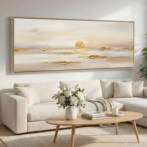 May include: A large horizontal rectangular wall art piece featuring an abstract landscape with a soft cream and beige background. The painting incorporates raised, textured gold paint strokes that mimic the appearance of sunlight reflecting on water.