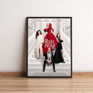 Könnte beinhalten: Gerahmtes Filmplakat für "Der Teufel trägt Prada" mit Meryl Streep, Anne Hathaway, Emily Blunt und Stanley Tucci. Das Plakat zeigt die Besetzung auf einer großen Treppe, mit dem Titel prominent dargestellt.