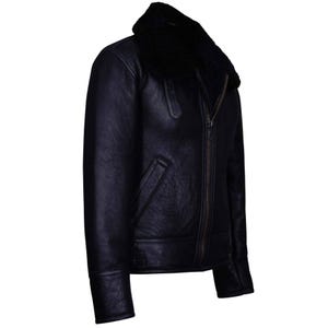 May include: A black leather jacket with a shearling collar. The jacket features a zip-up front, a pocket on the left side, and a classic aviator style. The jacket is made of a dark, possibly navy, leather.