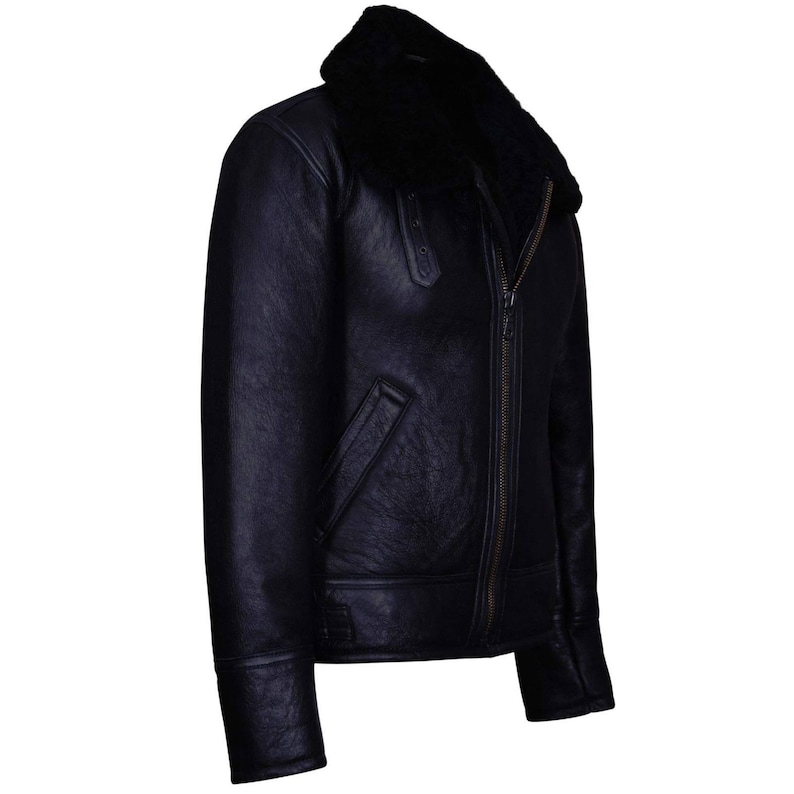 May include: A black leather jacket with a shearling collar. The jacket features a zip-up front, a pocket on the left side, and a classic aviator style. The jacket is made of a dark, possibly navy, leather.