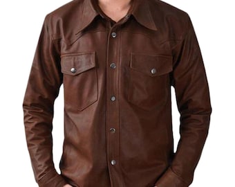 May include: Brown leather shirt with two chest pockets and snap closures. The long-sleeved shirt has a classic collar and a tailored fit. The shirt is made of a smooth, supple leather.