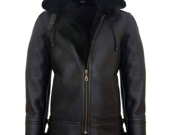 May include: Black leather jacket with a hood and a zipper closure. The jacket has a shearling lining and trim around the hood, cuffs, and hem. The jacket has a classic aviator style with a warm and cozy appearance.