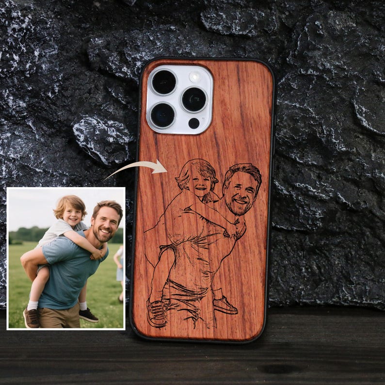 May include: A wooden phone case with a laser-etched image of a man carrying a child on his back. The case has a natural wood grain finish and a black border. A small photo of the same scene is in the corner.