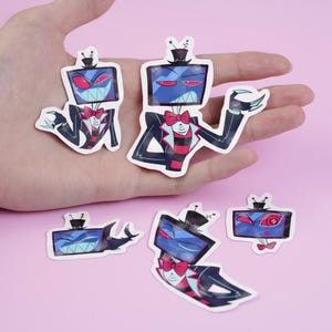 May include: A collection of cartoon-style stickers featuring a character with a television screen head, wearing a suit with a bow tie. The stickers have a blue, red, and black color scheme, with a pink background.
