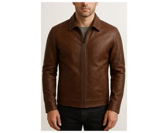 May include: A brown leather jacket with a collared neckline and a full-length zipper. The jacket has two front pockets and long sleeves. The model is wearing a gray t-shirt underneath and black pants.