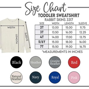 May include: A size chart for a toddler sweatshirt, Rabbit Skins 3317, with measurements in inches. The chart includes sizes 2T to 7T, with width, length, and sleeve measurements. Color options include black, heather, red, and more.