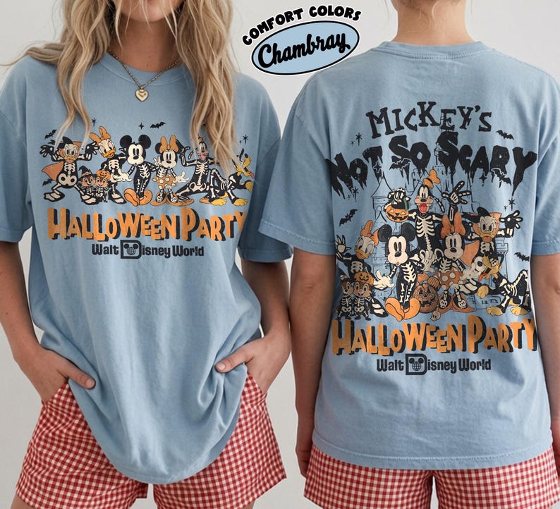 May include: A light blue t-shirt featuring a graphic of Disney characters in skeleton costumes. The front and back display the text Mickey's Not So Scary Halloween Party Walt Disney World. The shirt is labeled Comfort Colors Chambray.