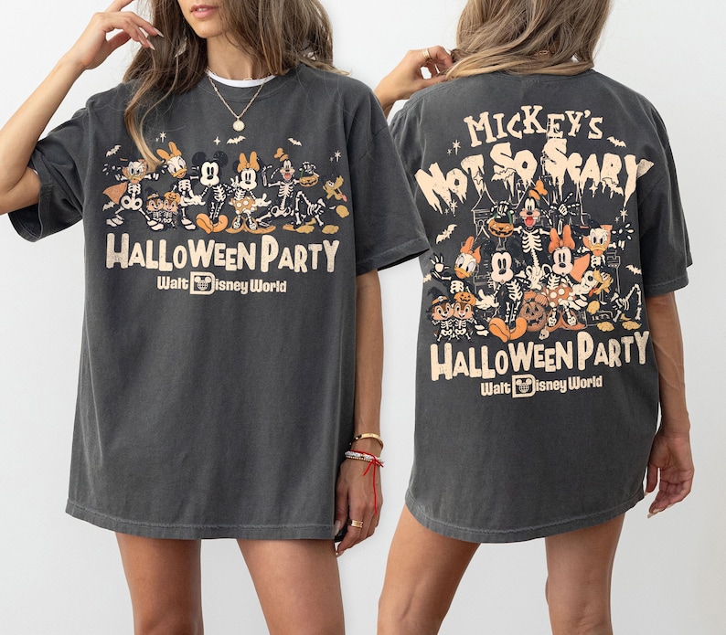 May include: A charcoal gray t-shirt featuring a graphic print of Disney characters in skeleton costumes. The front displays the text Mickey's Not So Scary Halloween Party Walt Disney World. The back shows a larger version of the same graphic.