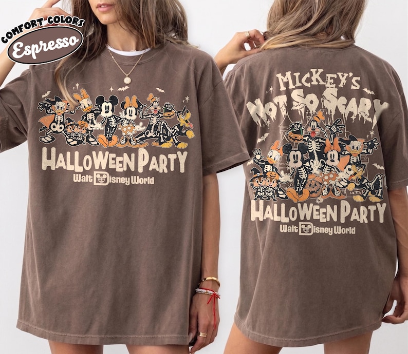 May include: A brown short-sleeve t-shirt featuring a graphic of Disney characters in skeleton costumes. The front displays the text "Halloween Party" and "Walt Disney World." The back features the text "Mickey's Not So Scary Halloween Party."