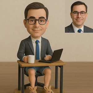 May include: A figurine of a man wearing a gray suit jacket, blue tie, glasses, and bunny slippers, seated at a small desk with a laptop and coffee mug. A smaller image of the man in a suit is in the background.