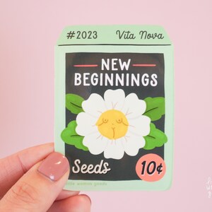 Naklejka winylowa New Beginnings - Ilustracja pakietu nasion ogrodowych Kwiat Feminist Girl Power Art Noworoczne inspirujące motywujące cytaty