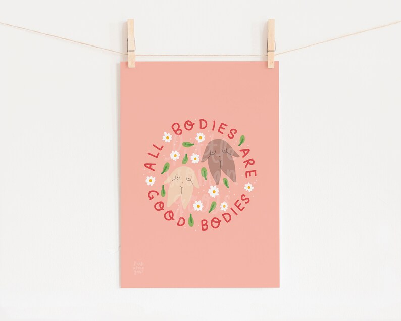 May include: A pink background with two cartoon bodies in a circle of white flowers and green leaves. The text "ALL BODIES ARE GOOD BODIES" is written in red around the circle.