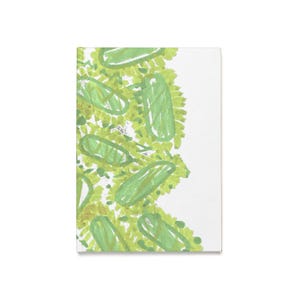 May include: A white rectangular notebook with a green and yellow abstract design. The design features green, oblong shapes with a lighter green fill, surrounded by a textured, yellow-green background. The notebook is blank on the right side.