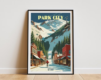 May include: A framed art print featuring a winter scene of Park City, Utah. The artwork depicts a snowy street lined with buildings, leading to a mountain with ski slopes. The text "PARK CITY SKI COUNTRY UTAH" is displayed at the top and bottom.