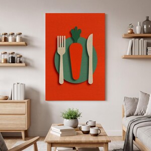 May include: A canvas print with a food-themed design. It features a large orange carrot with a green top, a beige fork, and a beige knife, all set against a red backdrop. The carrot sits on a green circle. The artwork is a modern, minimalist style.