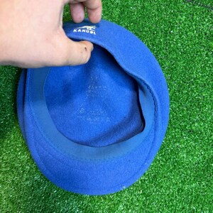 K&ouml;nnte beinhalten: Ein blauer Kangol-Barett. Der Hut besteht aus einem weichen Material und tr&auml;gt das Kangol-Logo. Der Barett ist ein klassischer Stil und hat eine einfarbige blaue Farbe.