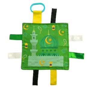 May include: A green fabric square with a mosque design and colorful fabric ribbons attached to each side. The mosque has a green dome with a crescent moon and star on top. The ribbons are green, yellow, white, and black.