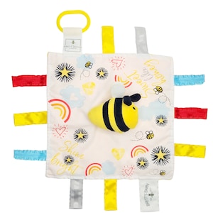 May include: A white baby sensory blanket with a yellow and black bee applique. The blanket has colorful satin ribbons attached to the edges and features a rainbow, stars, and the text "Honey you're sweet" and "Shine bright".