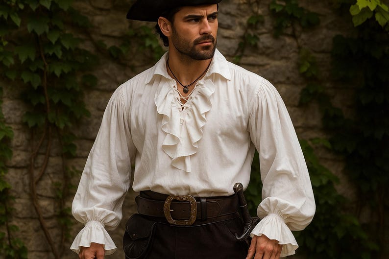 May include: A white pirate shirt with ruffled detailing on the front and cuffs. The shirt has long sleeves and is paired with a dark brown belt with a large buckle, black pants, and a black hat. A sword is attached to the belt.