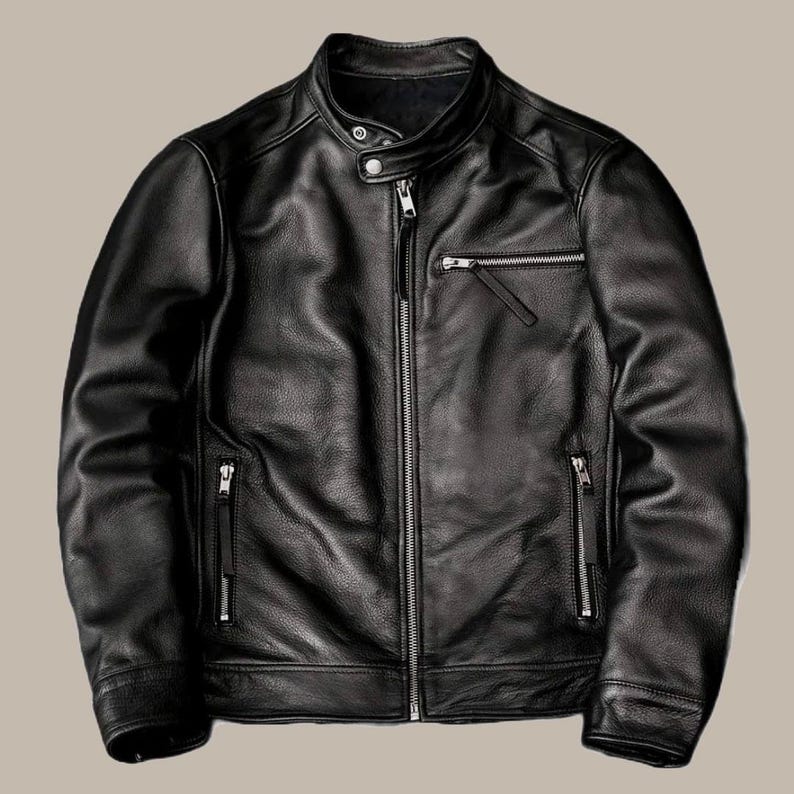 May include: A black leather jacket with a stand-up collar and multiple zippered pockets. The jacket has a front zipper closure and a classic, streamlined design. The leather appears to be smooth and has a slight sheen, suggesting a high-quality material.