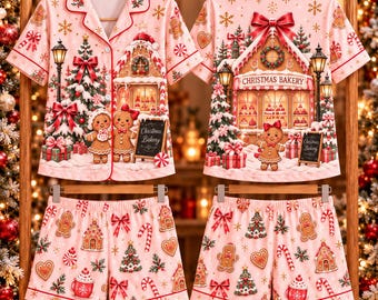 May include: A pink pajama set featuring a short-sleeved button-down shirt and matching shorts. The print displays gingerbread people, Christmas trees, candy canes, and a bakery storefront with the text Christmas Bakery.