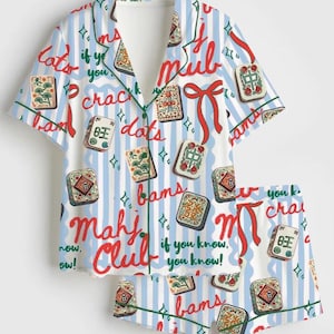 May include: A short-sleeve button-down pajama shirt and matching shorts set featuring a light blue and white vertical stripe pattern. The fabric is decorated with mahjong tile illustrations, red ribbons, and the text Mahj Club if you know, you know.