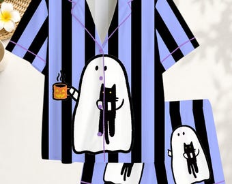 May include: A short-sleeve button-down pajama shirt and matching shorts set featuring vertical black and light purple stripes. The set displays a graphic of a white ghost holding an orange jack-o'-lantern mug and a black cat on the shirt and shorts.