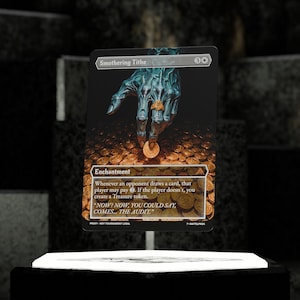 May include: A Magic: The Gathering card titled "Smothering Tithe." The card features a skeletal blue hand wearing a gold ring, dropping a gold coin onto a pile of coins. The card text includes the word "Enchantment."