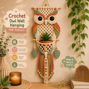 May include: A macrame owl wall hanging featuring cream, sage green, and terracotta cord with large black eyes and a central pocket holding a small green plant. The design includes wooden beads, leaf-shaped accents, and a long fringe tail.