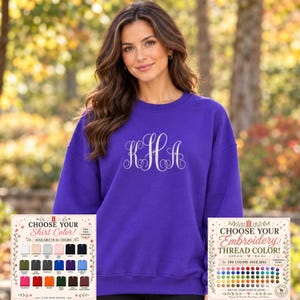 May include: A vibrant purple crewneck sweatshirt featuring a white embroidered monogram with the letters KHA in a decorative script font. Two informational cards are displayed at the bottom, showing shirt and thread color options.