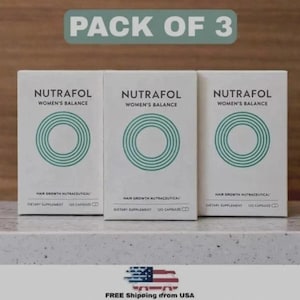 May include: Three white boxes of Nutrafol Women's Balance hair growth nutraceutical dietary supplement, each containing 120 capsules. The boxes have a green circular design and the text "PACK OF 3" is at the top.