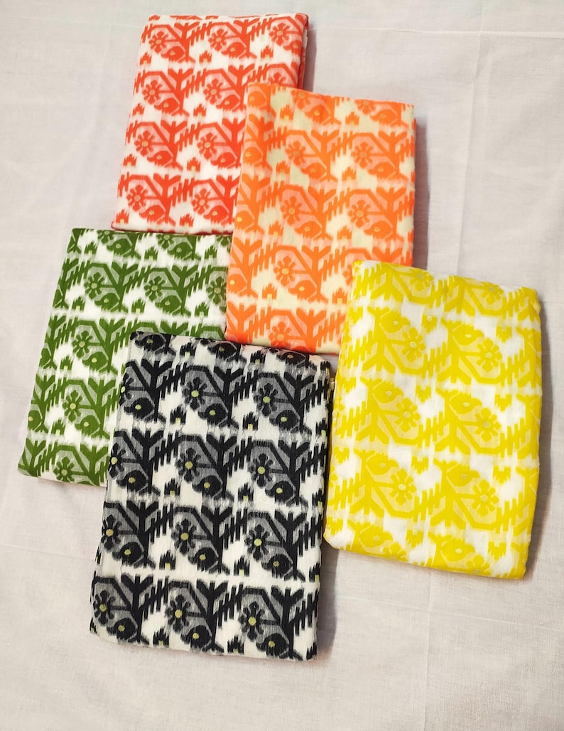 May include: Five folded fabric squares in various colors: orange, red, green, black and white, and yellow. Each square features a repeating floral pattern. The fabrics are arranged on a white surface.