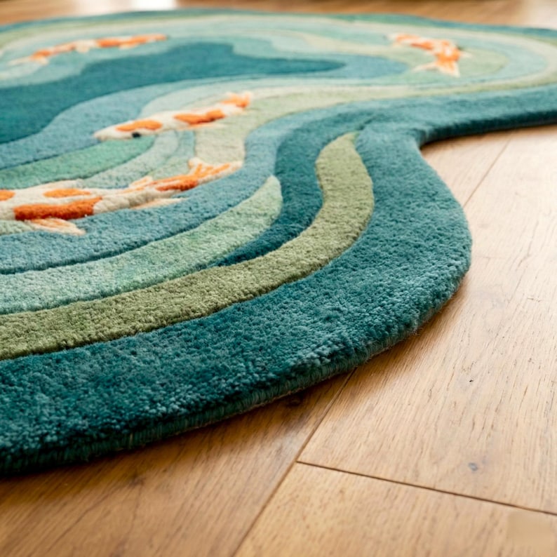 Close-up detail of plush hand tufted wool texture showing teal wave pattern and premium craftsmanship.