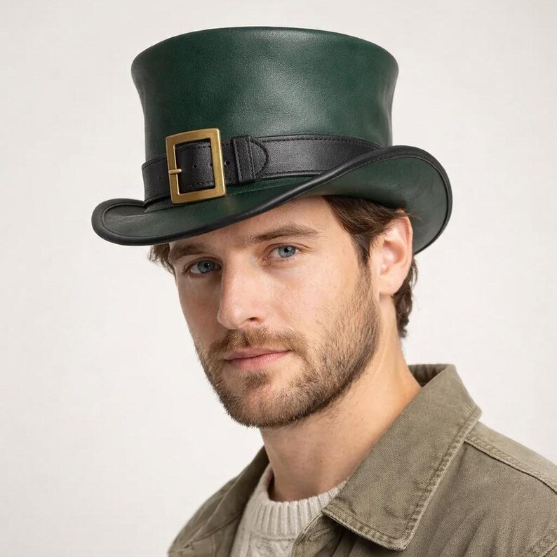 May include: A dark green top hat with a black band and a gold-colored buckle. The hat has a rounded crown and a slightly curved brim. The hat is made of a smooth material.