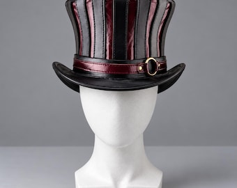 May include: A top hat featuring alternating vertical panels of black and dark red material. The hat includes a dark red band around the base, accented with a gold-toned metal ring and small studs. The brim is curved and black.
