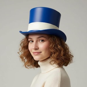 May include: A blue top hat with a white band. The hat has a classic design and is made of a smooth material. The hat is worn by a person with curly brown hair and a cream-colored turtleneck sweater.
