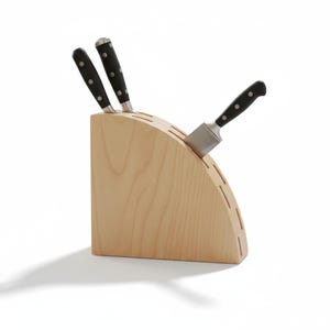 May include: A wooden knife block with three knives. The block is light-coloured wood with a curved design and slots for knives. The knives have black handles with silver blades. The knife block is on a white background.