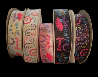 May include: Five spools of grosgrain ribbon arranged in a row. Three spools feature the text DO WHAT MAKES YOU FEEL fancy! alongside graphics of crowns, necklaces, and fans. Two spools display repeating patterns of colorful swirling dots.