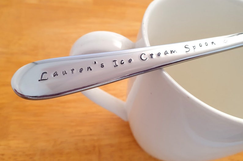 May include: A silver ice cream spoon with the words "Lauren's Ice Cream Spoon" engraved on the handle.