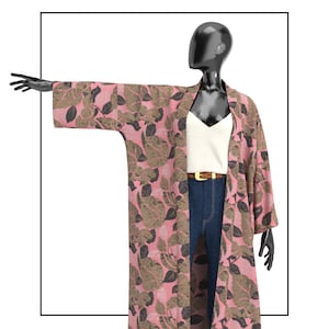May include: A long, open-front kimono robe featuring a pink base color with a repeating pattern of dark brown and tan leaves. The garment has wide, three-quarter length sleeves and a straight, loose-fitting silhouette that falls below the knees.